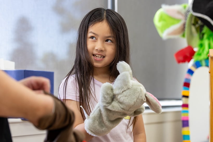 Child enjoying the Holyoake Attachment Program through play and creativity.