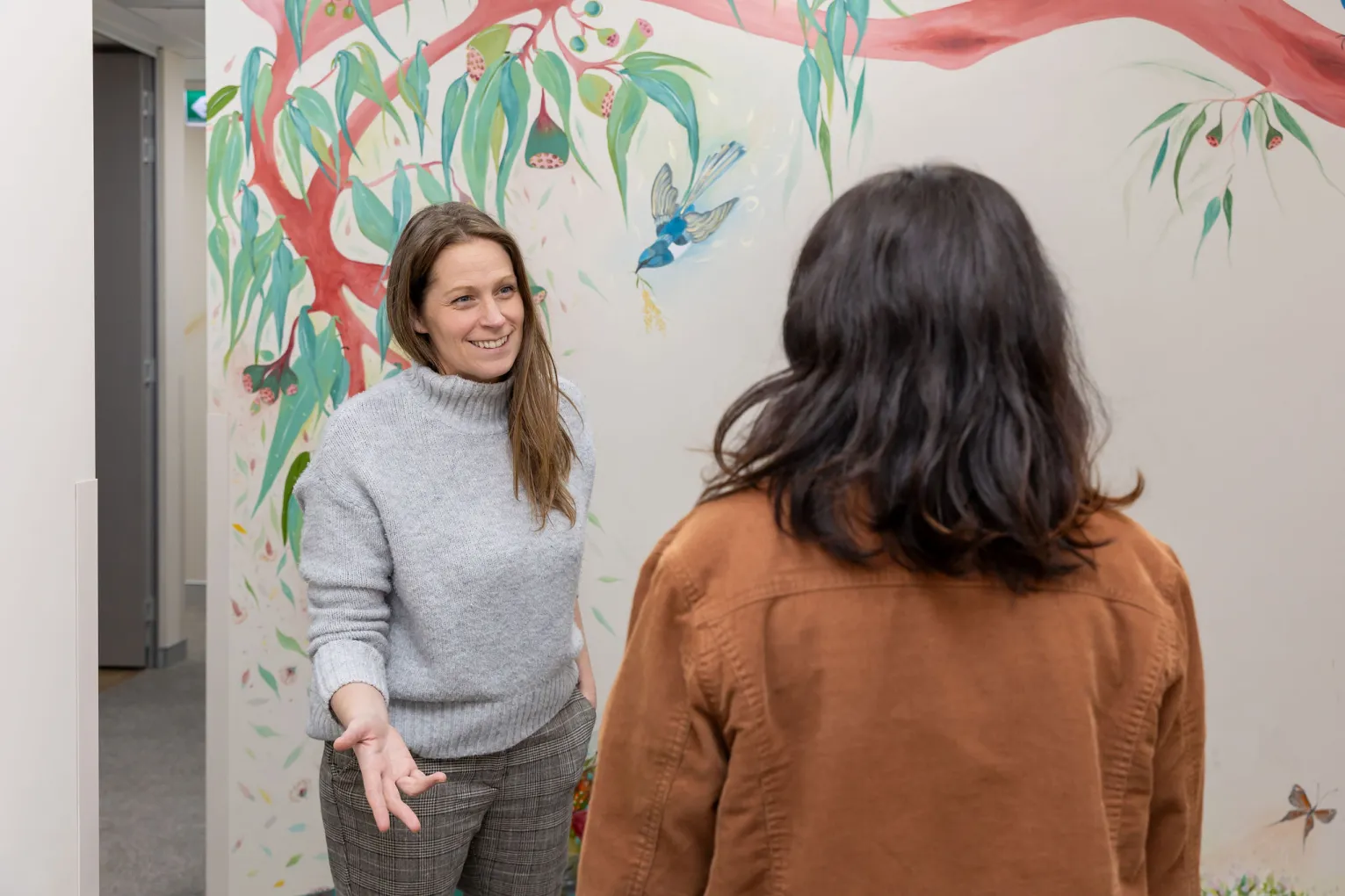 Woman talking to each other in hallway