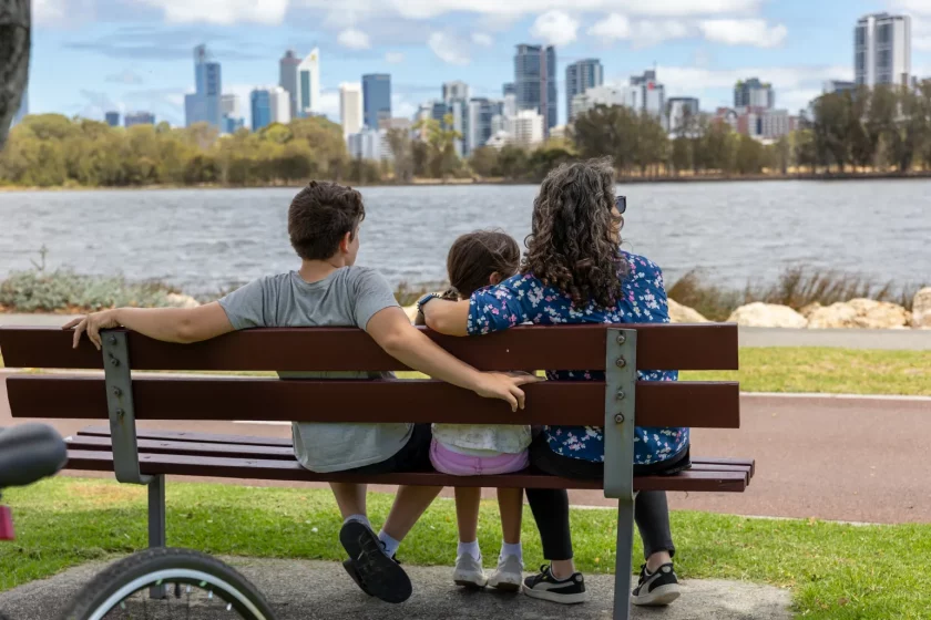 Family sitting on bench at South Perth foreshore