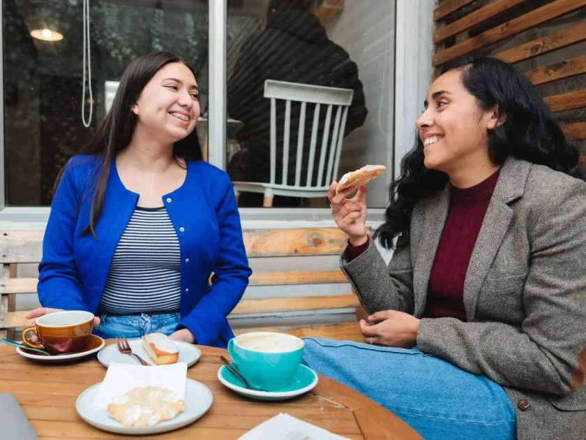 Two people connecting through a conversation over coffee